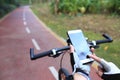 Cyclist hands use gps navigator on smartphone