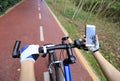 Cyclist hands use gps navigator on smartphone