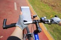 Cyclist hands use gps navigator on smartphone