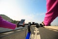 Cyclist hands use smartphone cycling