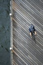 Cyclist in helmet with backpack rides wooden pier along the river