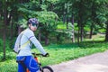Cyclist in helmet on orange bike riding in park Royalty Free Stock Photo