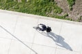 Cyclist with helmet riding a electric bicycle on a concrete way