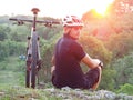 Cyclist with his mountain bike looking at the beautiful sunrise