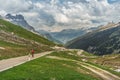 Cyclist on the Klausen pass road, mountain panorama in the Swiss Alps, Spiringen, Canton Uri, Switzerland Royalty Free Stock Photo