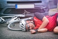 Cyclist lying on the road after hitting by a car Royalty Free Stock Photo