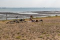 Cyclist lying on Southend beach on a hot sunny day.