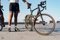 Cyclist man feet and bike wheel on coastal road Royalty Free Stock Photo