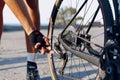 Cyclist man feet and bike wheel on coastal road Royalty Free Stock Photo