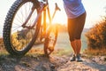 Cyclist man pushing a mountain bike up the hill close up image. Active travel on bicycle