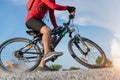 Cyclist man riding a mountain bike up a hill, extreme sport mountain biker