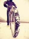 Cyclist man with winter bike stays in snow. Winter extreme sportive concept.