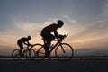 Cyclist in maximum effort in a road outdoors at sunset