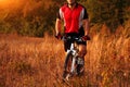 Cyclist on the Meadow Trail at tne Evening Royalty Free Stock Photo