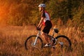 Cyclist on the Meadow Trail at tne Evening Royalty Free Stock Photo