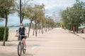 Cyclist in medical mask on a bike path on the promenade