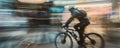 Cyclist in motion on city street with motion blur Royalty Free Stock Photo