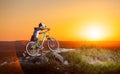 Cyclist with mountain bike on the hill in the evening Royalty Free Stock Photo
