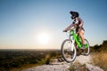 Cyclist with mountain bike on the hill under blue sky Royalty Free Stock Photo