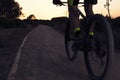 Cyclist on mountain bike riding by path at sunset Royalty Free Stock Photo