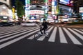 A cyclist passes through Shinjuku Crossing in Tokyo, Japan. Royalty Free Stock Photo