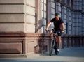 Cyclist passing historical buildings on bike Royalty Free Stock Photo