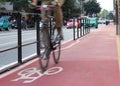 Cyclist passing over bicycle symbol in bike lane. Motion blur. Royalty Free Stock Photo