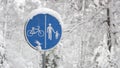 Cyclist pedestrian road sign Located in a snow covered park