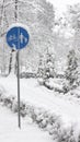 Cyclist pedestrian road sign Located in a snow covered park