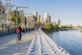 Cyclist and people walking across a bridge in