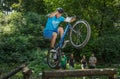 LVIV, UKRAINE - JUNE 2018: A cyclist performs tricks on a bicycle trial to overcome an obstacle course