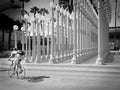 Cyclist posing in front of Urban Light at LACMA