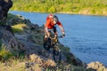 Cyclist in Red Jacket Riding Mountain Bike on the Beautiful Spring Rocky Trail above the River. Extreme Sport Concept Royalty Free Stock Photo