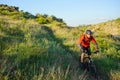 Cyclist in Red Jacket Riding Mountain Bike on the Beautiful Spring Trail. Travel and Adventure Sport Concept Royalty Free Stock Photo