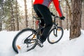 Cyclist in Red Riding Mountain Bike in Beautiful Winter Forest. Adventure, Sport and Enduro Cycling Concept. Royalty Free Stock Photo