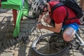 LVIV, UKRAINE - MAY 2018: The cyclist repairs his bicycle by pumping a punctured wheel Royalty Free Stock Photo