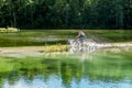 Cyclist rides a bicycle across the river at the ford Royalty Free Stock Photo