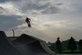 The cyclist rides in an extreme park. The stuntman. The skate park, rollerdrome, quarter and half pipe ramps. Extreme sport, youth Royalty Free Stock Photo