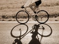 cyclist rides fast against the light with a racing bike on the a Royalty Free Stock Photo