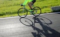 cyclist rides fast against the light with a racing bike on the a Royalty Free Stock Photo