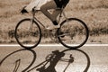 cyclist rides fast against the light with a racing bike on the a Royalty Free Stock Photo