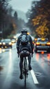 Cyclist rides on road carriageway, sharing path with passing cars