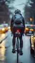 Cyclist rides on road carriageway, sharing path with passing cars