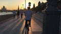 Cyclist rides on Strida along the embankment in Moscow