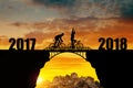 Cyclist riding across the bridge into the New Year 2018. Royalty Free Stock Photo