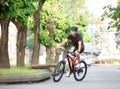 Cyclist riding along empty city streets Royalty Free Stock Photo