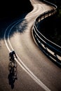 Cyclist riding along a mountain road Royalty Free Stock Photo