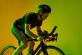 Cyclist riding a bicycle isolated against neon background Royalty Free Stock Photo