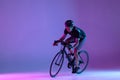 Cyclist riding a bicycle isolated against neon background Royalty Free Stock Photo