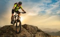 Cyclist Riding the Bike on Autumn Rocky Trail at Sunset. Extreme Sport and Enduro Biking Concept. Royalty Free Stock Photo